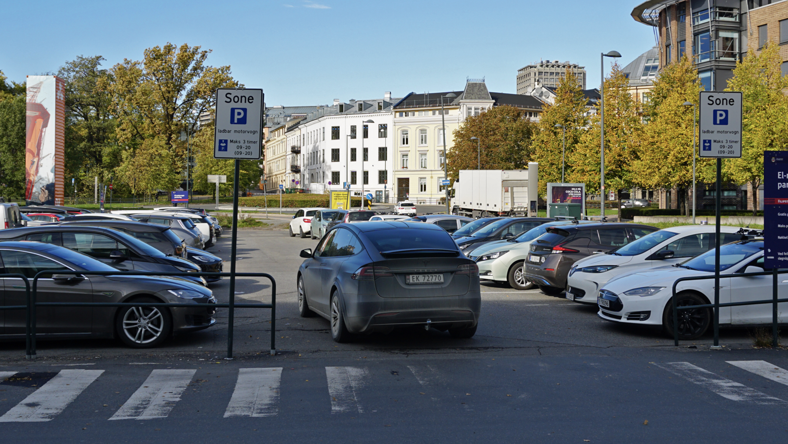 Tesla Says Their Supervised Full Self-Driving Will Automatically Find a Free Spot Even in a Busy Parking Lot & Park Itself